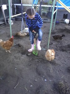 Farm Girl digging in the dirt for an appreciative audience with gymnastic apparatus in the background.